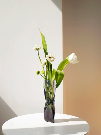 Modern transparent glass vase with flowing lines design