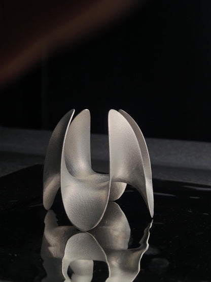 A sculptural incense holder crafted from aerospace-grade aluminum alloy, featuring a flowing cyberpunk-inspired form and a matte silver finish. Designed for modern interiors, meditation spaces, or futuristic decor setups.